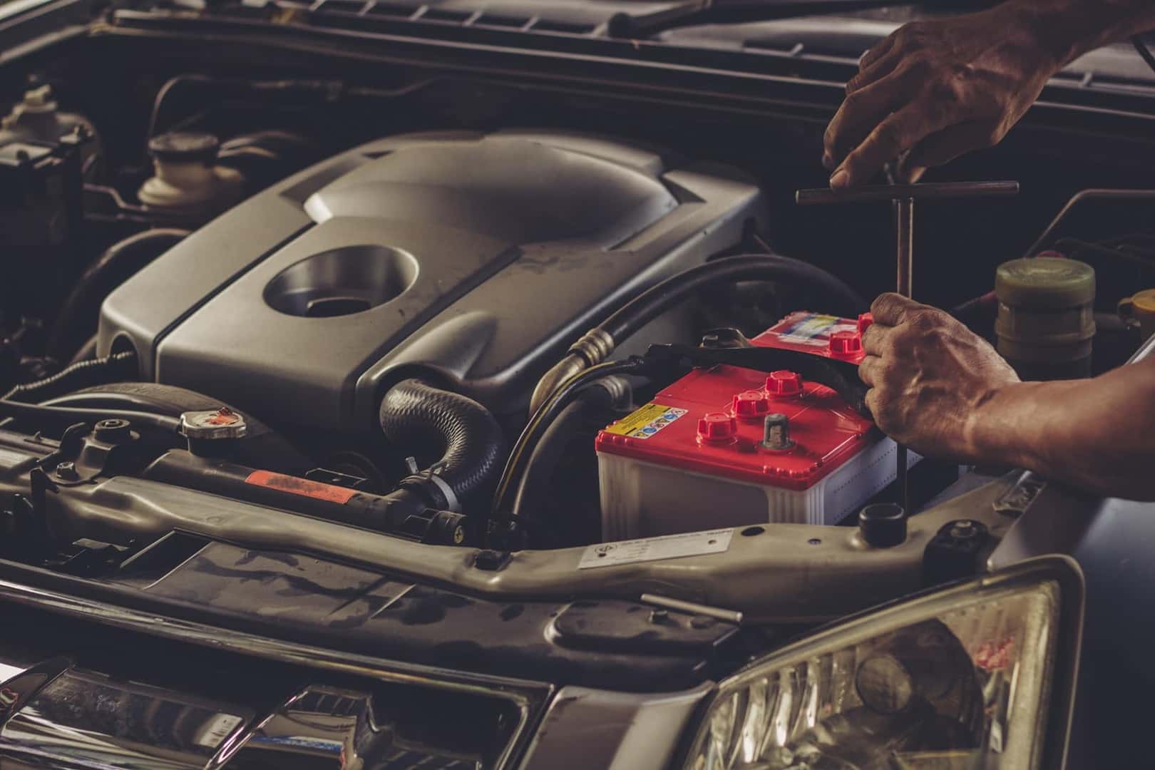 Mechanic fixing car battery