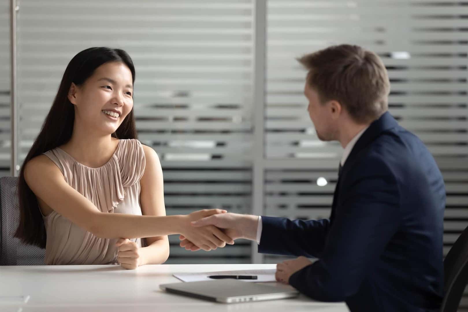 Woman shaking man's hand