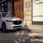White Mazda CX-5 SUV outside store