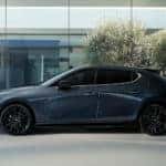 Gray Mazda 3 Hatchback man inside building