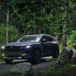 Blue Mazda CX50 Green Trees