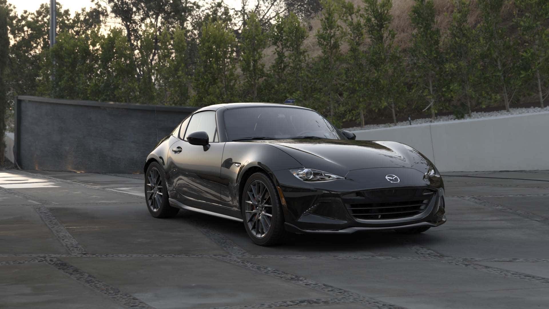 Black Mazda MX-5 Miata sports car Outside Trees Wall