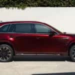 Red Mazda CX-90 SUV Woman Plants Garage