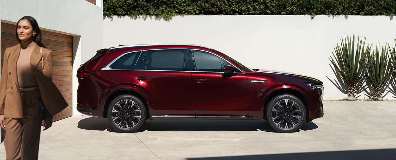 Red Mazda CX-90 SUV Woman Plants Garage