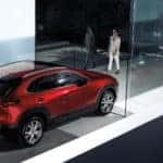 Red Mazda CX-90 SUV Woman Glass Building