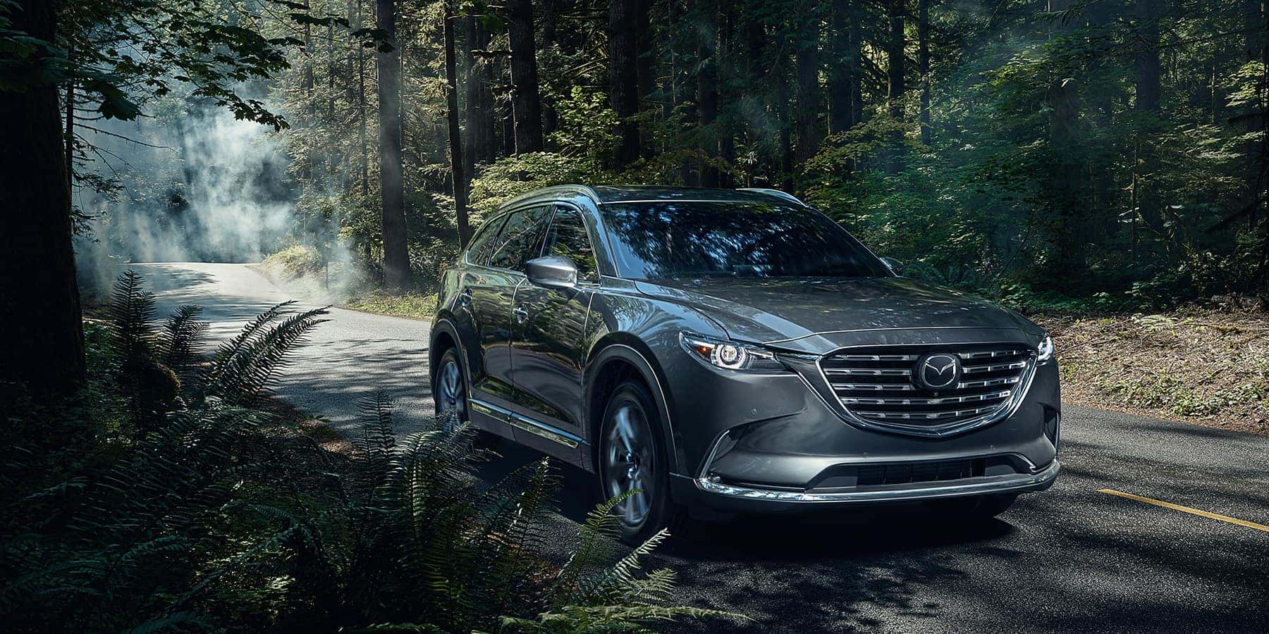 Green Mazda CX-9 SUV Outside Trees