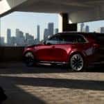 Red Mazda CX-90 SUV Man Garage Buildings