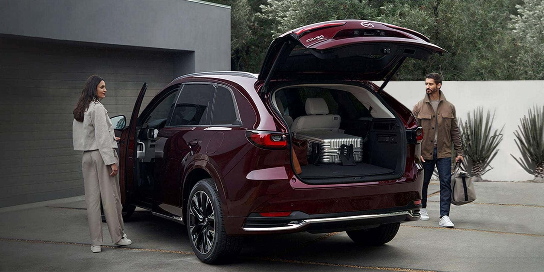 Red Mazda CX-90 SUV Two People Building 