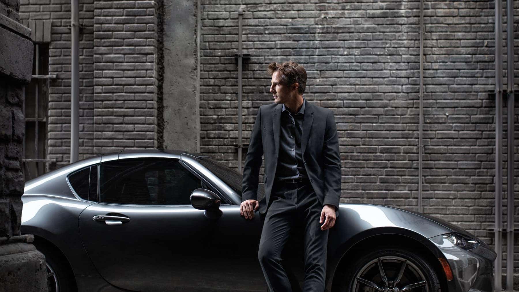 Gray Mazda Miata Sports Car Man Black Wall Black Suit