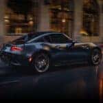 Gray Mazda Miata MX-5 Sports Car Open Road Buildings