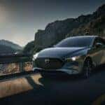Blue Mazda 3 Hatchback Ocean Water Mountains