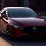 Red Mazda 3 Hatchback Brick Road