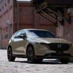 Green Mazda CX-5 SUV Building