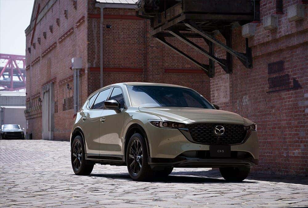 Green Mazda CX-5 SUV Building