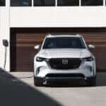 White Mazda CX-90 SUV Brown Garage Door
