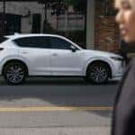 White Mazda CX-5 SUV Building Person