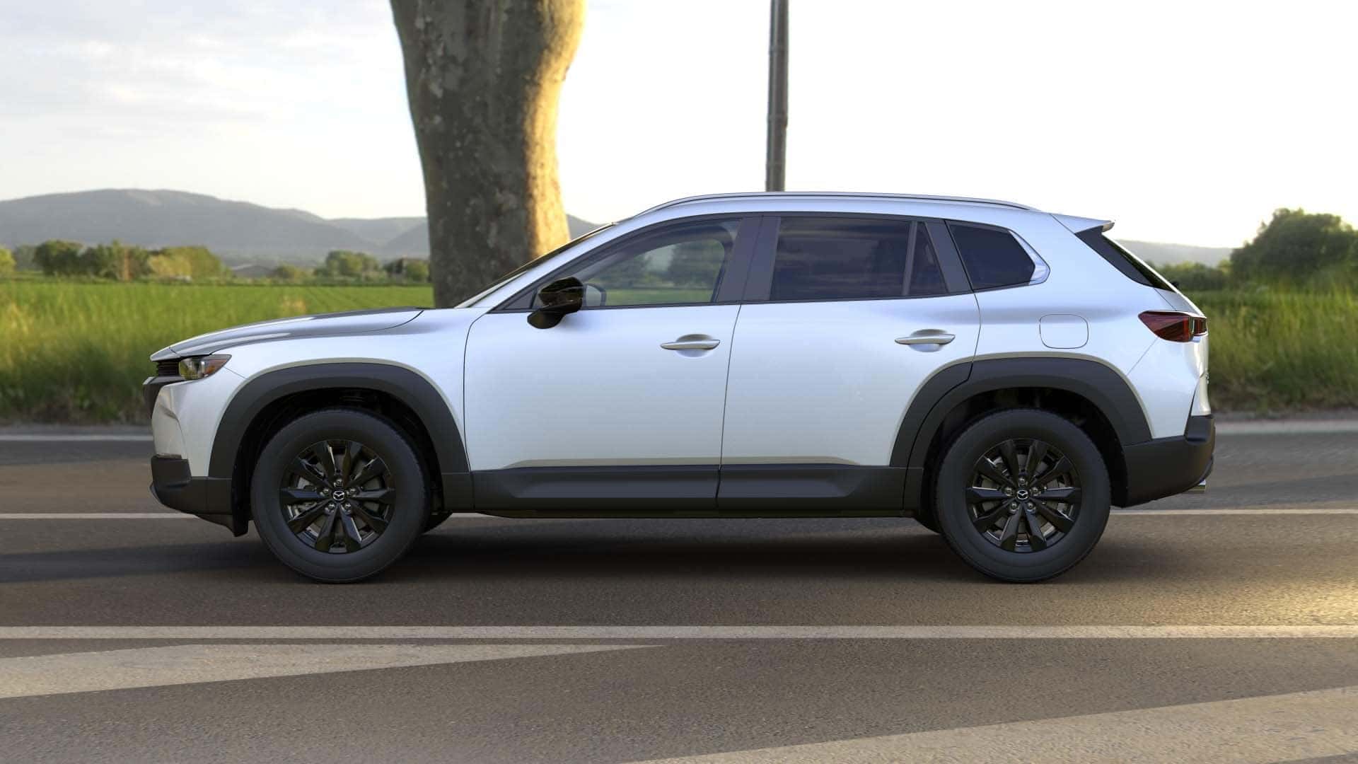 Silver Mazda CX-50 Road Grass