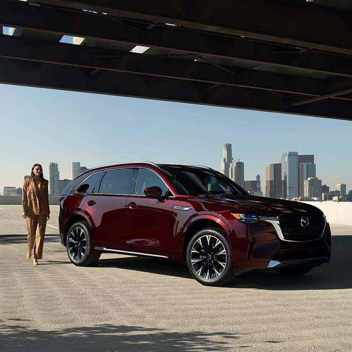Burgundy Mazda CX-90 SUV Woman Buildings