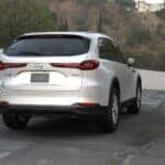 White Mazda CX-90 SUV Outside Trees