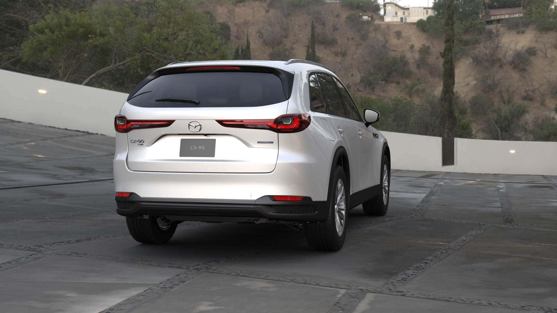 White Mazda CX-90 SUV Outside Trees