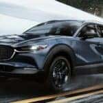 Gray Mazda CX-30 SUV Snow Buildings