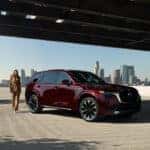 White Mazda CX-90 PHEV SUV White Building Brown Garage Door