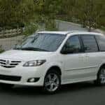 White Mazda Minivan Trees White Fence