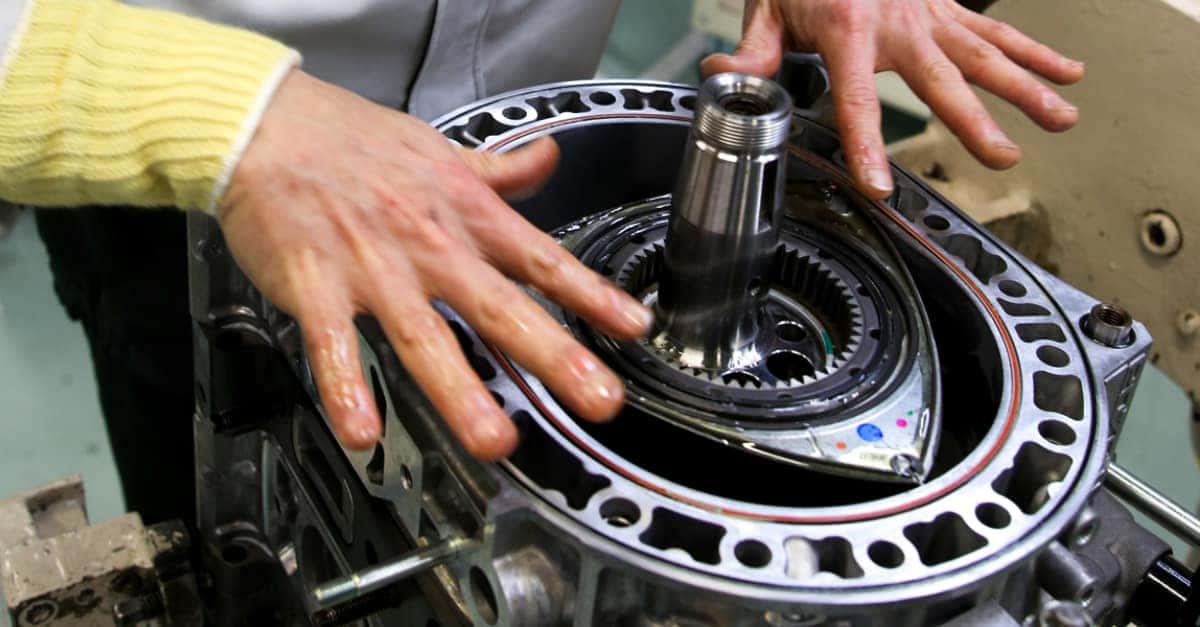 Metal Rotary Engine Hands Yellow Sweater