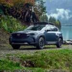 Blue Mazda CX-50 SUV Water Trees
