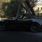 Black Mazda MX-5 Miata Sports Car House Trees