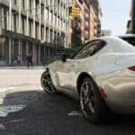 Cream Mazda Miata MX-5 Sports Car Buildings People