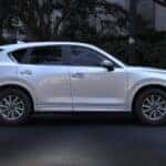 White Mazda CX-5 SUV Trees