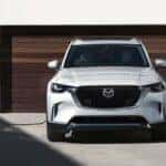 White Hybrid Mazda CX-90 SUV Building