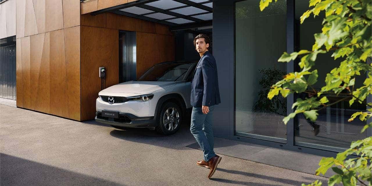 White Mazda MX-30 SUV Man Tree Brown Wall