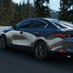 Gray Mazda3 Sedan Snow Green Trees
