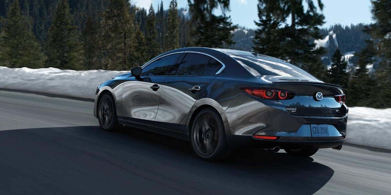 Gray Mazda3 Sedan Snow Green Trees