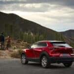 Red Mazda SUV Mountains People