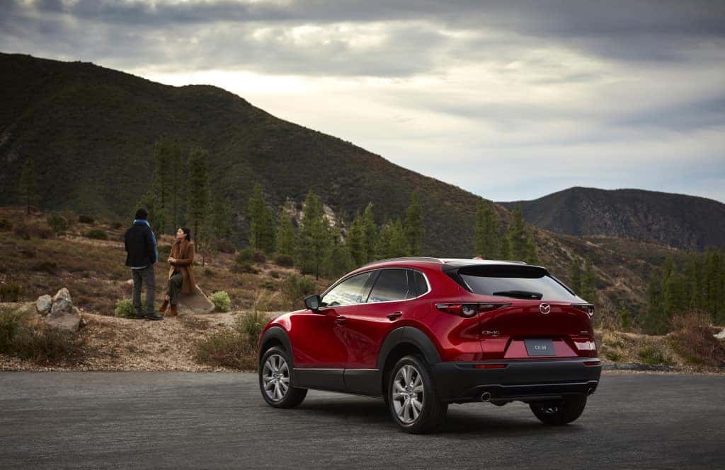 Red Mazda SUV Mountains People