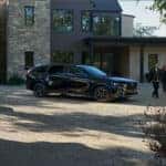 Black Mazda CX-70 SUV Man Woman Brick House