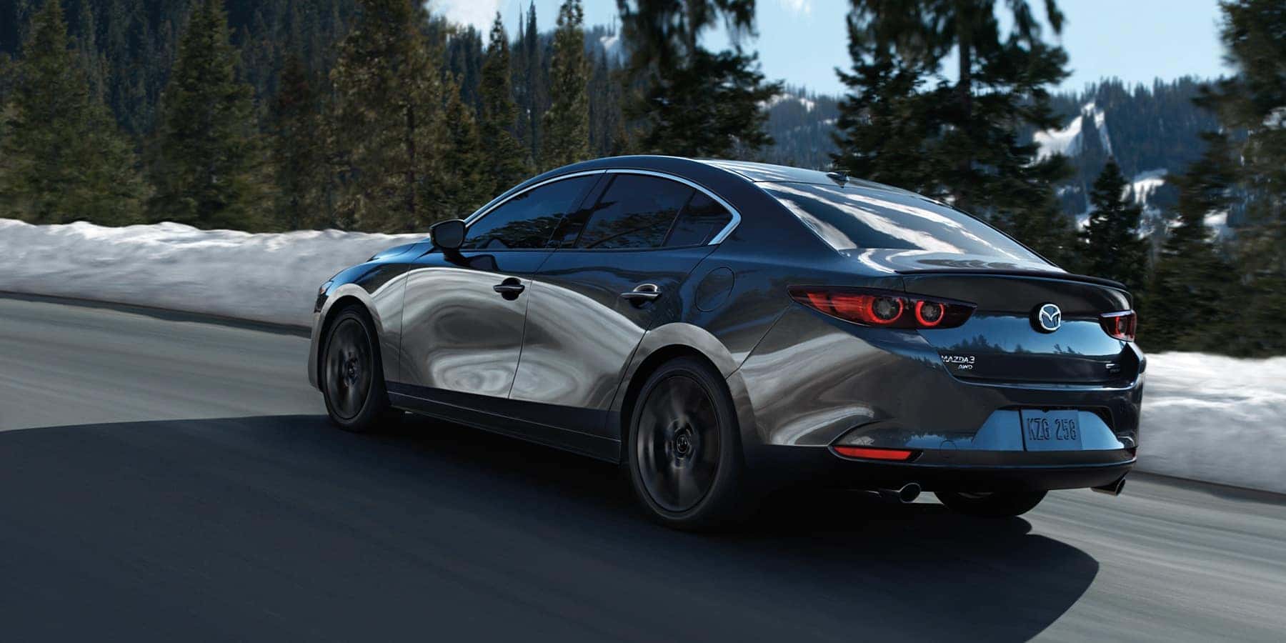 Gray Mazda 3 Sedan White Snow Green Trees