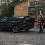 Black Mazda CX-70 SUV People Wood Table Building