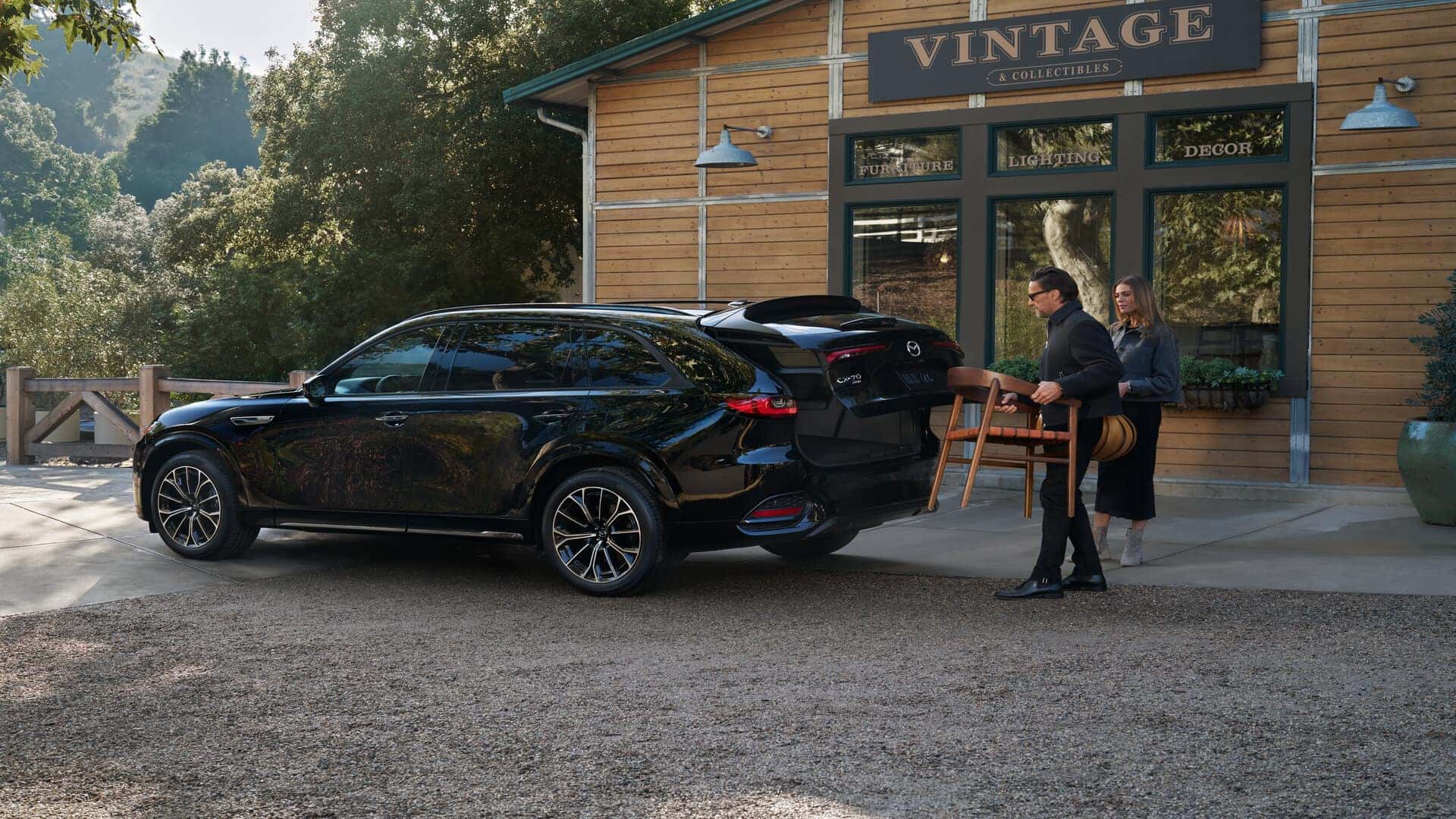 Black Mazda CX-70 SUV People Wood Table Building