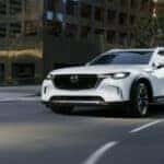 White Mazda CX90 SUV Brown Building
