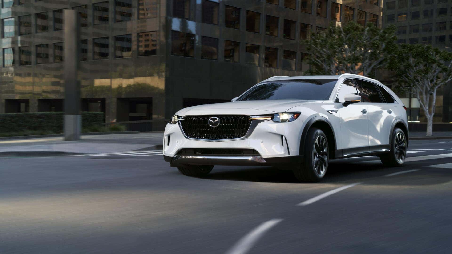 White Mazda CX90 SUV Brown Building