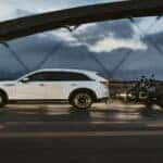 White Mazda CX-90 SUV Motorcycle Bridge