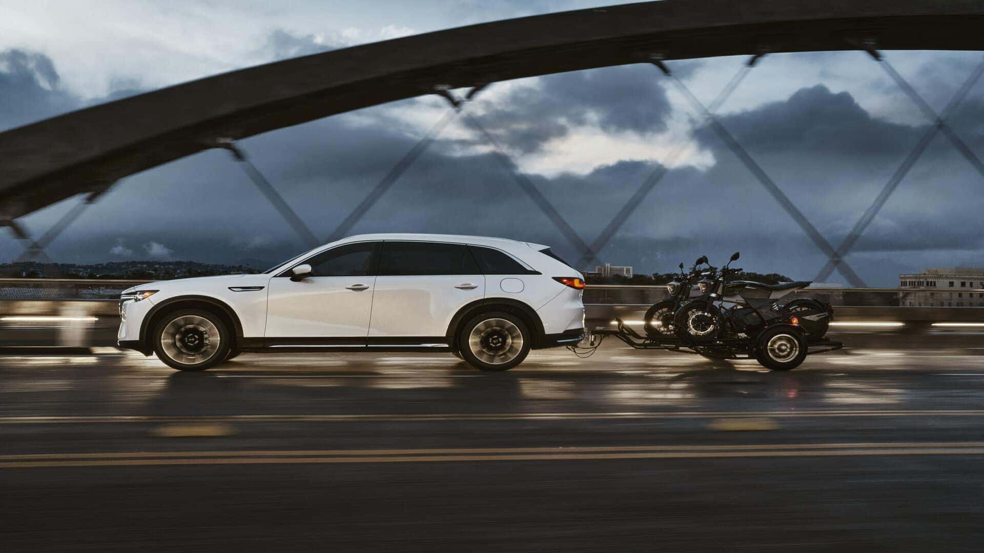 White Mazda CX-90 SUV Motorcycle Bridge