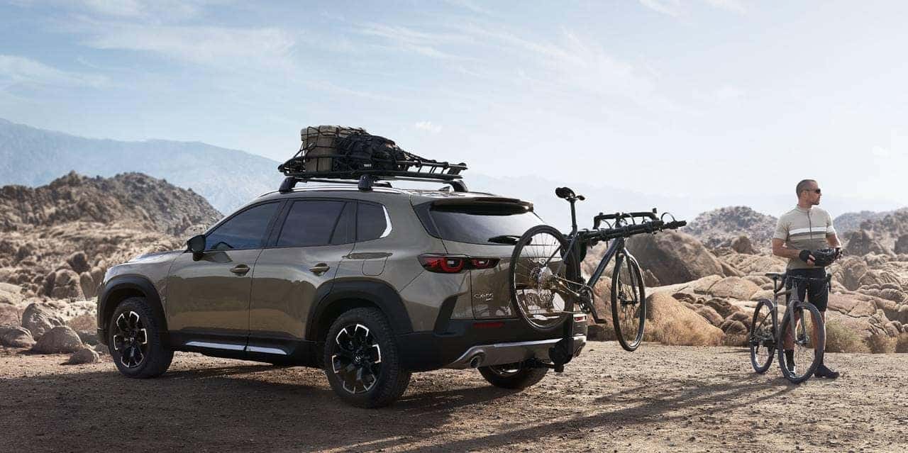 Brown Mazda CX-50 SUV Man Bike Bike Rack Brown Rocks