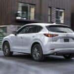 White Mazda CX-5 SUV Brown Building
