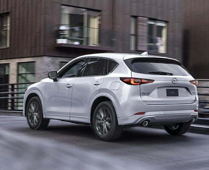 White Mazda CX-5 SUV Brown Building