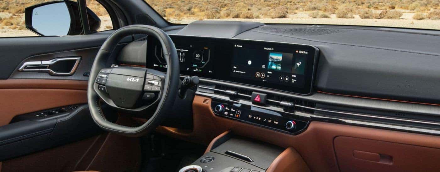 2026 Kia Sportage front interior view of the steering wheel and infotainment.